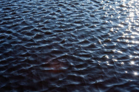 Water surface texture background. Water surface pattern with sunbeams.の写真素材