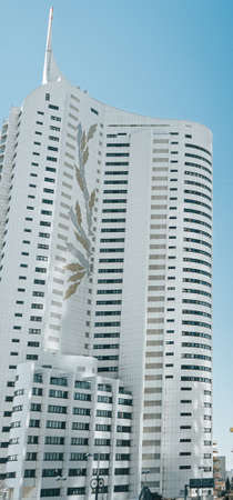 White skyscaper with cool styling painting on the side.
