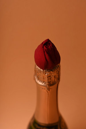 Champagne bottle and rosebud. Symbol of love and romanceの写真素材