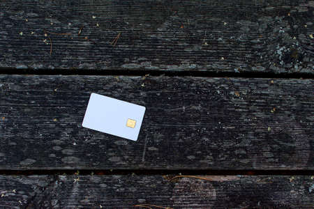 Bank card on a wooden table in nature. The concept of payment for nature.の写真素材