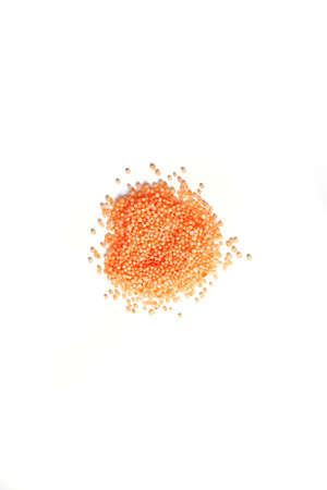 Small orange balls on a white background. Round bath salt. Isolate.の写真素材