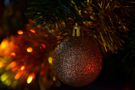 Christmas tree toy - a shiny ball close-up and shallow depth of field.