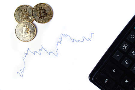 Graph of changes in exchange rates, calculator and bitcoin coins on a white background. Isolate.の写真素材