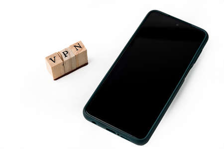 Isolate of wooden letters folded into the word VPN and smart phone. Abbreviation of the word Virtual Private Network.の写真素材