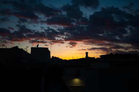 Silhouette of roofs of houses in the old district in Barcelona, Spain on sunset.の写真素材