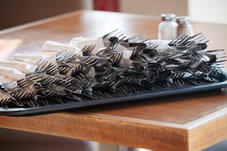 On Tray On Table Are Prepared Sets Of Eating Utensils - Knifes And Forks In Napkins. Greek cafe