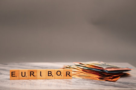 Word EURIBOR Is Written In Wooden Letters, Near Stack of Money Of 5, 10, 20 and 50 Euro Banknotes.