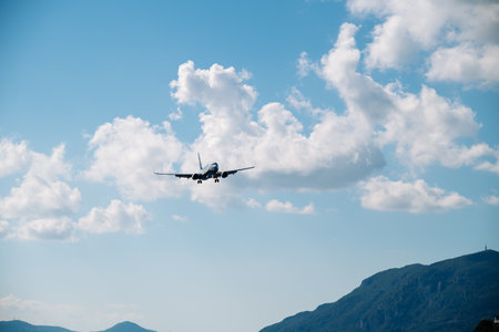 Kerkyra, Greece - 09 24 2022: Ryanair Plane Is Landing On The Background Of The Blue Sky And Mountains. The Concept Of Emergency Landing And Technical Malfunctions Of The Aircraft.のeditorial素材
