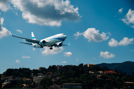 Kerkyra, Greece - 09 24 2022: Close-up of Enter air landing at short runway, against the backdrop of the hills with the houses of the city of Corfu.のeditorial素材