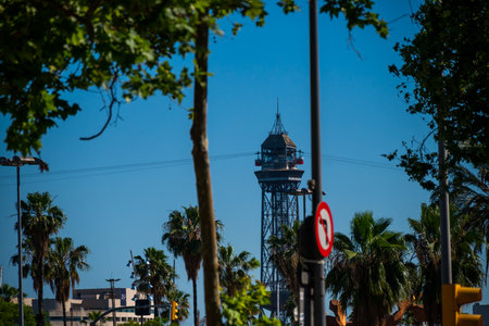 Barcelona, Spain - May 26 2022: Red carriages ride the cable car and pass the tower in Barcelona.のeditorial素材