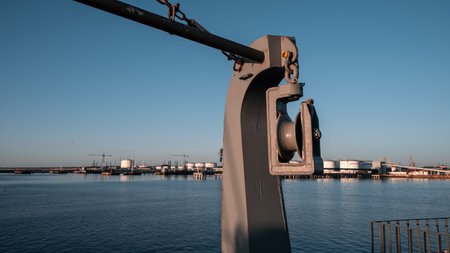 A metal pole with a chain hanging from it is in front of a body of water