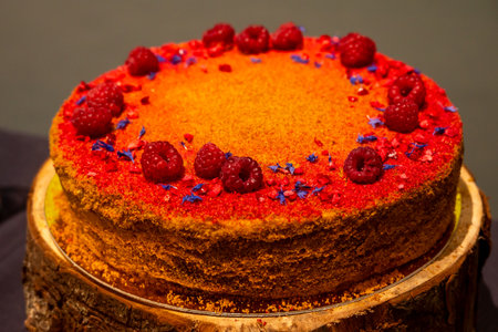 A yummy cake with raspberries and blue sprinkles, great for any celebrationの写真素材