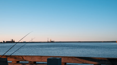 A calm body of water with a pier in the backgroundの写真素材