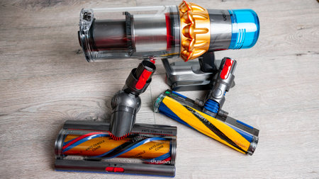 Jurmala, Latvia 07.07.2024: Close-up of Dyson V15 detect absolute with hoover nozzles on the floor ready to use.のeditorial素材