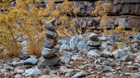A large pile of carefully stacked rocks in rugged terrainの写真素材