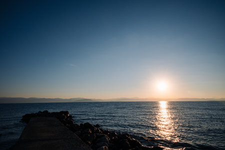 The ocean is calm and the sky is blue