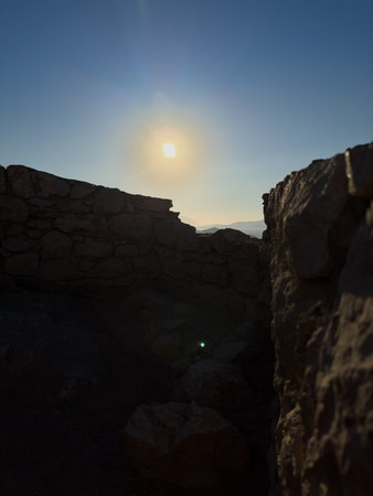 Sunset View Through Rocky Ruins in a Serene Landscape at Duskの写真素材
