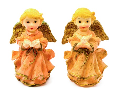 Photo of statuettes of porcelain angels with book and pigeon isolated on white backgroundの写真素材