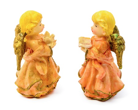 Photo of statuettes of porcelain angels with book and pigeon isolated on white backgroundの写真素材