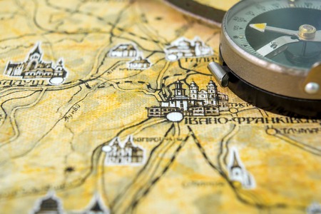 Photo of brown old vintage map on aged page with retro compassの写真素材