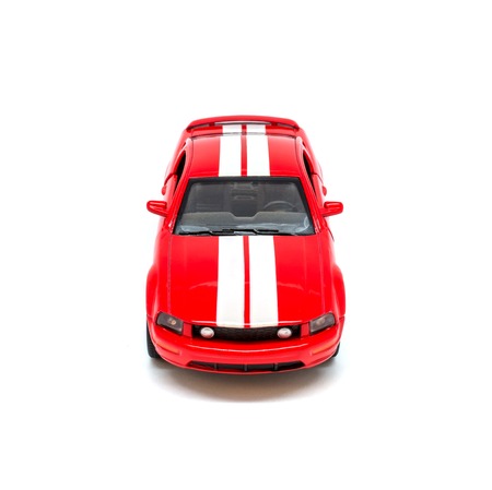 Photo of small red toy model car isolated on white background