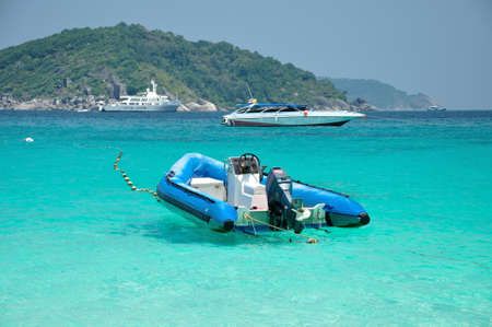 Motor boat floating on clear blue andamand sea, Thailand 