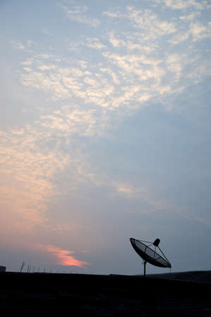 Silhouette of satellite dish antenna for television in the sunrise background, Thailand 