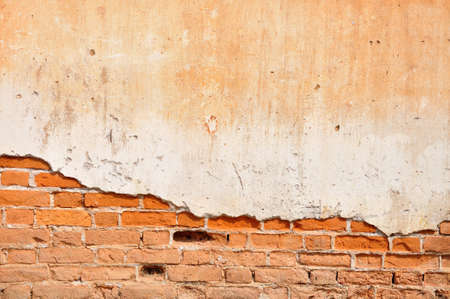 Red clay stained on the white exposed brick concrete wall 