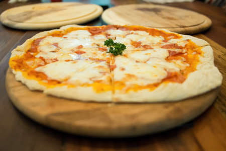 Margarita pizza produces from wood fired oven and 2 empty pans arrange as micky mouse face の写真素材
