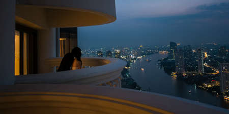 Couple in romantic night scene at 56th terrace of hotel の写真素材