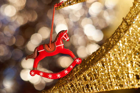 Christmas red toy horse on a Christmas treeの写真素材