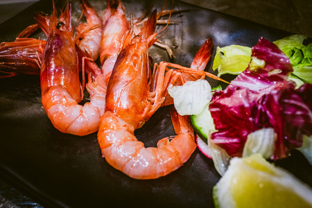 Grilled prawns with green salad, radicchio and lemonの写真素材