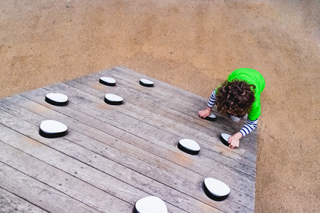 child climbing a playground gameの写真素材