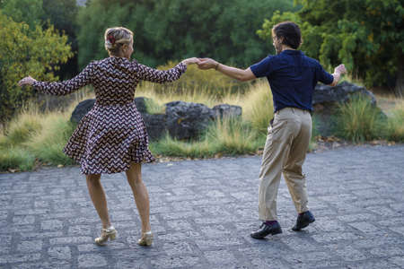 Swing dancers dancing outdoors.の写真素材
