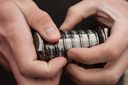 Human hands that are trying to open an old conundrumの写真素材