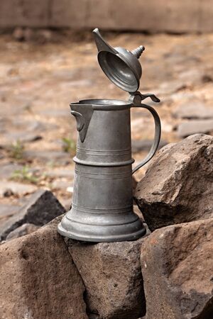 old tin container for beverages based on basalt rocks