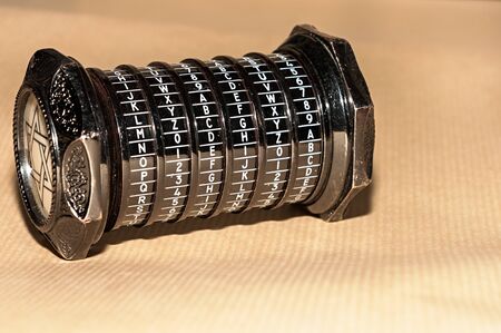 Old, painted black, metallic puzzle with letters and numbersの写真素材