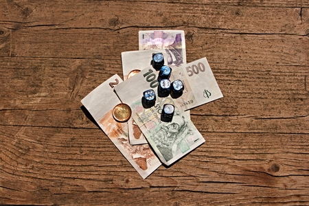 Wooden table on which are placed the dice on a few paper billsの写真素材