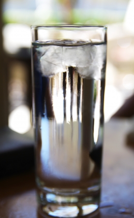 Glass of water with ice in a bar in Athensの写真素材
