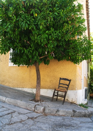 Lonely chair under a tree in central Athensの写真素材