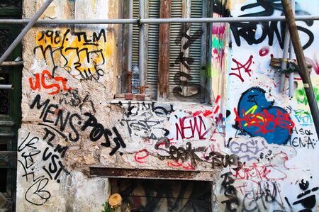 Lot of grafitti on a house wall and windowのeditorial素材