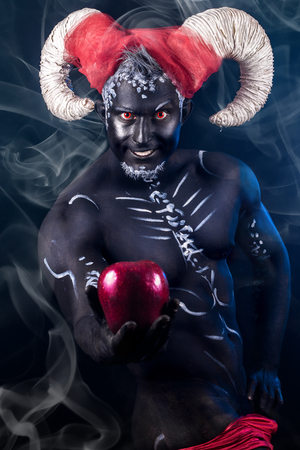 Fiery demon. A burning demon with horns and an apple of discord.の写真素材