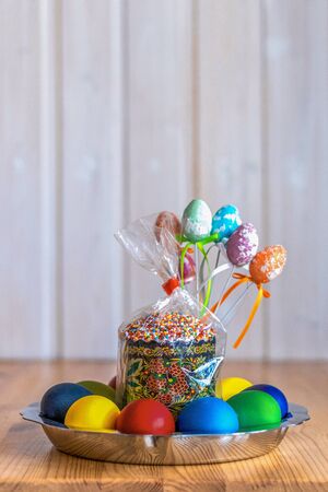 Easter eggs and Easter cake on a wooden tableの写真素材