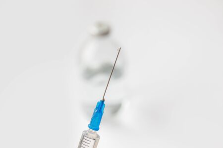 Needle with a drop, syringe on a white isolated backgroundの写真素材