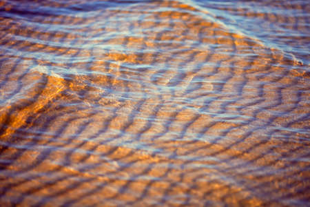 Yellow sand under the clear water of the seaの写真素材