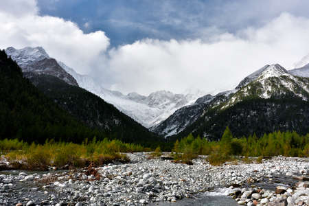 Val Sissone in early autumn, when the first snow surprise the larches still green.の写真素材