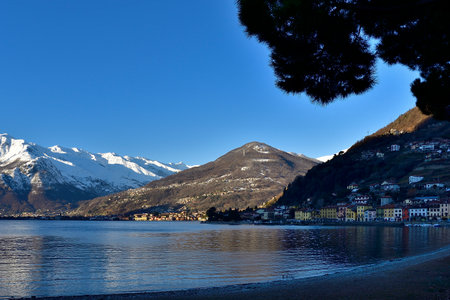 Picture of Monte Bregagno taken from the Domaso shore on the Como lake, with its colored houses on the right.の写真素材