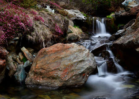 A creek in the heart of the Alps create a beautiful set of waterfallの写真素材
