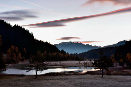 Pian di Gembro is a natural park in the center of the Alps. The colors in autumn at the sunrise make this place magnificent.の写真素材