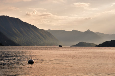 Ferryboat sailing in Como lake at the sunsetの写真素材